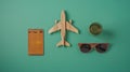 Generative AI Composition with ticket credit card wooden plane and sunglasses on green background business concept