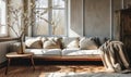 Cozy Modern Living Room with Comfortable Sofa, Soft Cushions, Elegant Throw, Wooden Side Table and Dried Flowers in Bright Royalty Free Stock Photo