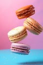 Generative AI Cretive shot made of colorful french macaroons and popcorn Rainbow of sweet cookies on rosy backgrou