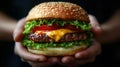 Generative AI Crop anonymous person with appetizing burger with fresh lettuce pork and cheese on dark background b