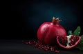 Generative AI, Fresh Juicy whole or half of pomegranate fruit with water drops, still life on dark background. Royalty Free Stock Photo