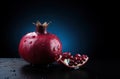 Generative AI, Fresh Juicy whole or half of pomegranate fruit with water drops, still life on dark background. Royalty Free Stock Photo