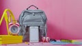 Generative AI Hipster grey leather backpack full of school supplies blank screen cell phone earphones pink yellow