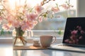 Generative AI Home work place with laptop, cup of hot drink and blooming brunch in vase on coffee table near windo Royalty Free Stock Photo