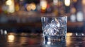 Generative AI ice cube in an empty glass on a bar counter in bar or pub business concept. Royalty Free Stock Photo