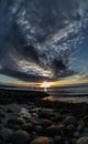 Beautiful cloudy sunset over the rocky sea shore at evening Royalty Free Stock Photo