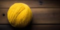 Generative AI illustration of bright yellow woolen yarn ball arranged on wooden floor Royalty Free Stock Photo