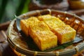 Generative AI Image of Fried Yellow Tofu Food with Banana Leaf in a Bamboo Tray