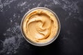 Generative AI Image of Top View of Peanut Butter in a Jar on Dark Background