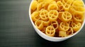 Uncooked rotelle pasta: Playful wagon wheel-shaped pieces, ready to twirl and soak up flavors