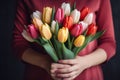 Generative AI International Women's Day. A woman holds a bouquet of colorful tulips. Close-up view. Happy Mother