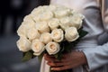 Generative AI International Women& x27;s Day. A woman holds a lush bouquet of white roses. Close-up view. Happy