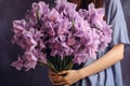 Generative AI International Women& x27;s Day. A young woman in dress holds a lush bouquet of purple irises. Close-up