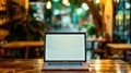 Generative AI Laptop with blank screen on wood table with cafe coffee shop blur background business concept. Royalty Free Stock Photo