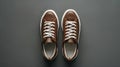 Generative AI Leather brown mens sneakers with white laces and rubber soles on gray background Flat lay top view M