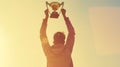 Generative AI a man holding up a gold trophy cup as a winner in a competition toned with a retro vintage instagram Royalty Free Stock Photo