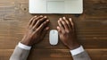 Generative AI Man typing on laptop computer keboard over wood office desk table with white wireless mouse Top view Royalty Free Stock Photo