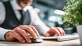 Generative AI Man working at his computer in the office selective focus of the hands using mouse business concept. Royalty Free Stock Photo