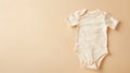 Generative AI Organic cotton bodysuit romper on beige background Baby clothes Fashion newborn clothes Flat lay top Royalty Free Stock Photo