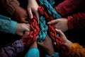 Generative AI, peoples hands working together to untangle a knotted rope.