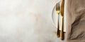 Plate with folded napkin and gold cutlery on grunge white background 3