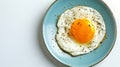 Generative AI Top view of delicious breakfast of fried egg with yellow yolk served on blue ceramic plate on table Royalty Free Stock Photo