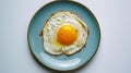 Generative AI Top view of delicious breakfast of fried egg with yellow yolk served on blue ceramic plate on table Royalty Free Stock Photo