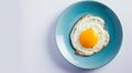 Generative AI Top view of delicious breakfast of fried egg with yellow yolk served on blue ceramic plate on table Royalty Free Stock Photo