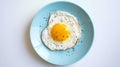 Generative AI Top view of delicious breakfast of fried egg with yellow yolk served on blue ceramic plate on table Royalty Free Stock Photo