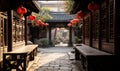 Traditional Chinese courtyard architecture with red lanterns hanging in a serene alleyway, embodying ancient cultural heritage and Royalty Free Stock Photo