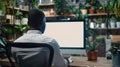Generative AI Unrecognizable black businessman using computer with empty blank screen sitting at workplace in offi