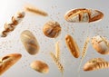 Generative AI Various types of bread, ears of wheat flying on gray background. Classic wheat round bread, baguette