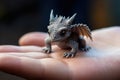 Generative AI, very small, tiny dragon in the hands, very cute and adorable.