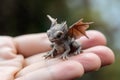 Generative AI, very small, tiny dragon in the hands, very cute and adorable.