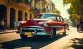 Vintage red classic car cruising on a sunny street in Havana with historical architecture and tropical vibes, capturing the Royalty Free Stock Photo