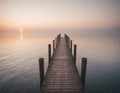 A wooden pier at misty dawn in a still sea Royalty Free Stock Photo