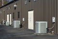 Generic Air Conditioner Compressors Behind Strip Office Building