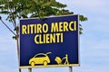 Generic billboard with written in Italian `load goods, customers` Royalty Free Stock Photo