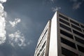 Generic high rise building towards blue sky with clouds