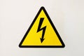 Generic high voltage danger sign, symbol. Sign of danger high voltage symbol on the white wall. Warning icon Royalty Free Stock Photo