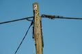 Generic, high voltage and telephone cable system seen supported by a wooden pole. Royalty Free Stock Photo