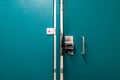 Generic metal public bathroom stall latch closed with the door gap shown. Royalty Free Stock Photo