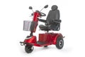 Generic mobility scooter for disabled or elderly people against Royalty Free Stock Photo