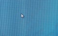 Generic mouse cursor pointer on a desktop PC monitor computer teal display screen detail closeup simple minimal shot, isolated, Royalty Free Stock Photo