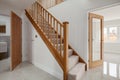 Generic new home entrance hall with wooden stairs