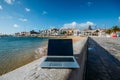 Generic notebook laptop on sunny deserted sandy beach background Royalty Free Stock Photo