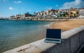 Generic notebook laptop on sunny deserted sandy beach background