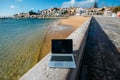 Generic notebook laptop on sunny deserted sandy beach background