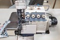 Generic old used and dirty semi-professional sewing machine being tested on the repair bench after service