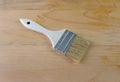 Generic paintbrush atop old pine boards